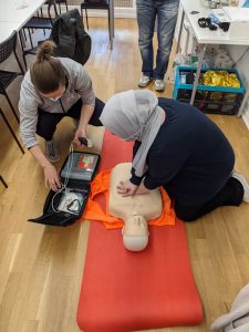 woman learning cpr from instructor
