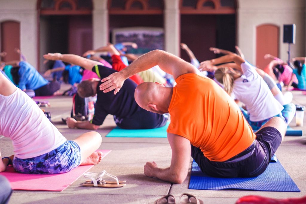 group of people stretching in yoga exercise class
