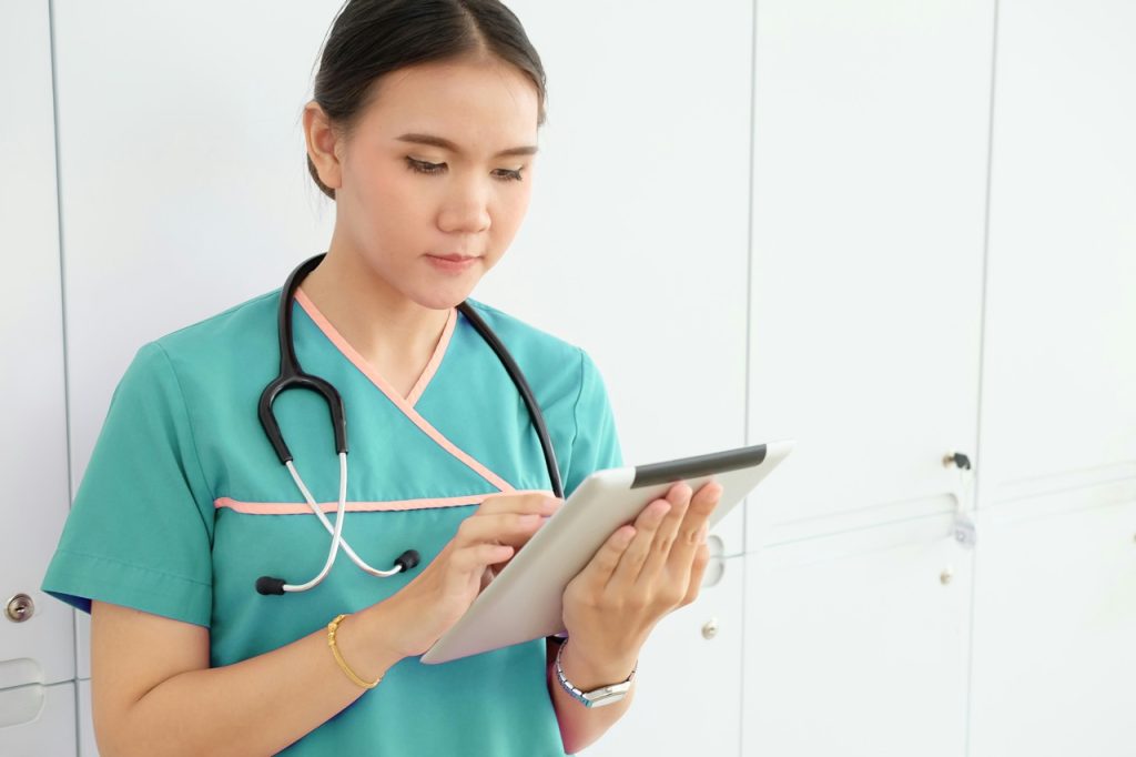 CNA with tablet device in hand